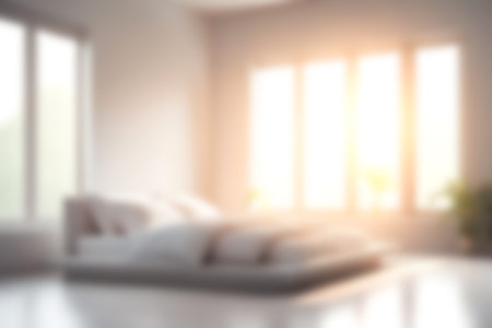 Blur modern bedroom at home with morning soft sunlight at big window for background usage. blur interior background concept. white, bright tone.の写真素材