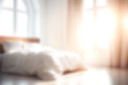 Blur modern bedroom at home with morning soft sunlight at big window for background usage. blur interior background concept. white, bright tone.の写真素材