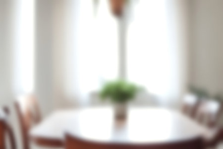 Blur modern dining room at home with soft sunlight at big window for background usage. blur interior background concept. bright tone.の写真素材