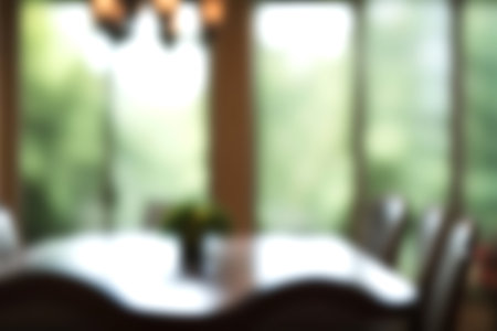 Blur modern dining room at home with soft sunlight at big window for background usage. blur interior background concept. bright tone.の写真素材