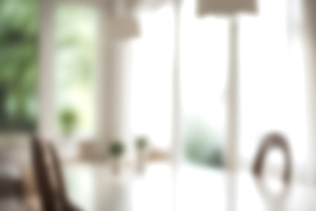 Blur modern dining room at home with soft sunlight at big window for background usage. blur interior background concept. bright tone.の写真素材