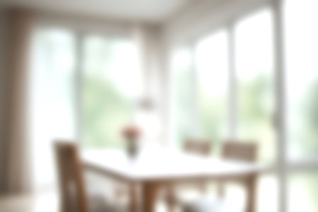 Blur modern dining room at home with soft sunlight at big window for background usage. blur interior background concept. bright tone.の写真素材