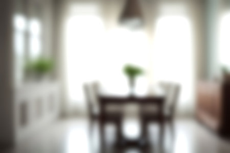 Blur modern dining room at home with soft sunlight at big window for background usage. blur interior background concept. bright tone.の写真素材