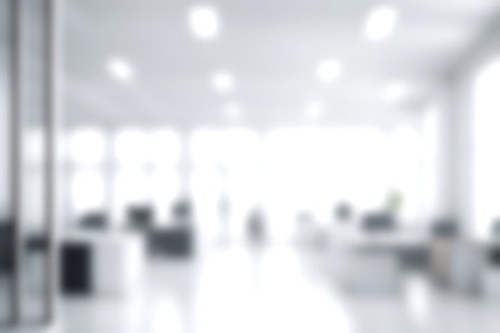 Blur open office with soft sunlight at big window for background usage. blur interior background...