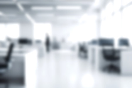 Blur open office with soft sunlight at big window for background usage. blur interior background concept. white and bright tone. Business concept.の写真素材