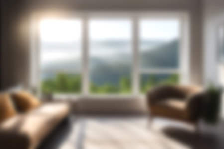 Blur modern livingroom with hill and soft sunlight at big window for background usage. blur interior background concept. white and bright tone. Business concept.の写真素材