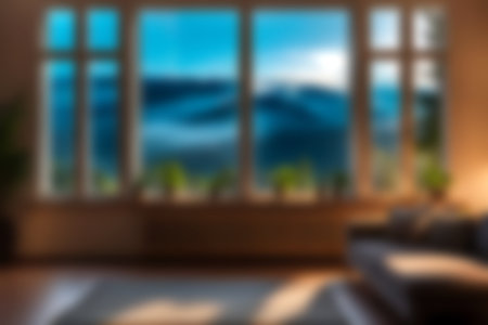 Blur modern livingroom with hill and soft sunlight at big window for background usage. blur interior background concept. white and bright tone. Business concept.の写真素材