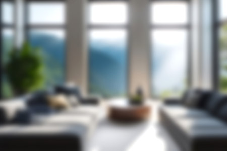 Blur modern livingroom with hill and soft sunlight at big window for background usage. blur interior background concept. white and bright tone. Business concept.の写真素材