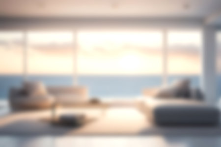 Blur modern livingroom with sea sky and soft sunlight at big window for background usage. blur interior background concept. white and bright tone. Business concept.の写真素材