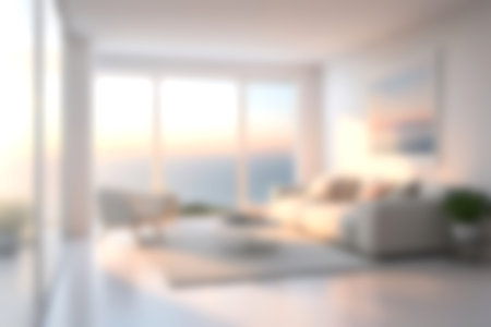 Blur modern livingroom with sea sky and soft sunlight at big window for background usage. blur interior background concept. white and bright tone. Business concept.の写真素材