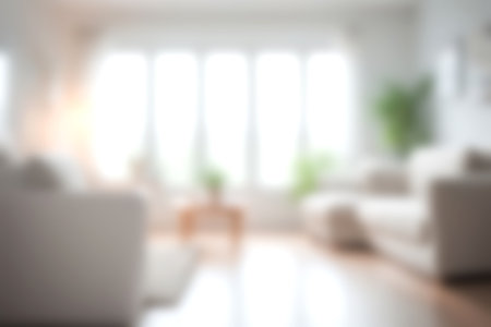 Blur modern livingroom at home with soft sunlight at big window for background usage. blur interior background concept. white and bright tone. Business concept.の写真素材