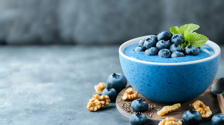 Blueberry smoothie bowl with walnuts and blueberries on grey backgroundの写真素材