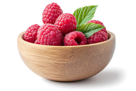 Ripe raspberries in wooden bowl isolated on white background.