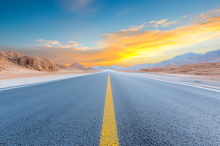 Asphalt road in the desert at sunset. Nature landscape background.の写真素材