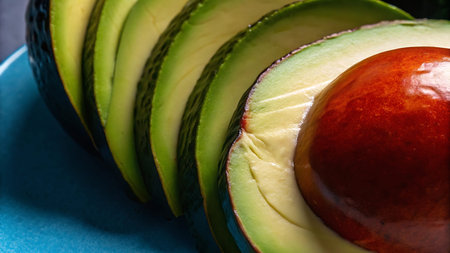 Avocado slices on blue plate. Close up. Selective focus.