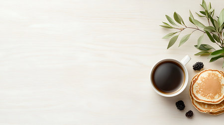 Cup of coffee and pancakes with blackberry on wooden table. Top view with copy space