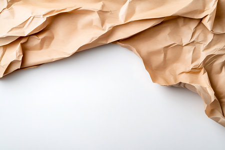 close up of crumpled brown paper on white background with copy spaceの写真素材