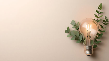 Light bulb with eucalyptus branches on beige backgroundの写真素材