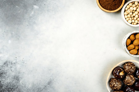 Chickpeas, hazelnuts, cashew nuts and ground coffee on a stone background.の写真素材
