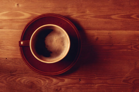 Cup of coffee on wooden table. Top view with copy spaceの写真素材