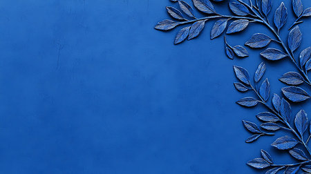 Blue leaves on a blue background with copy space. Minimal style.の写真素材