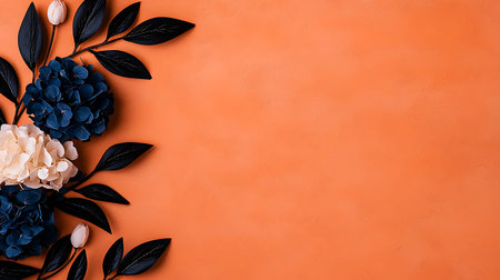 Creative layout made of black leaves and hydrangea flowers on orange background. Flat lay, top view,...