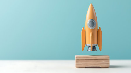 3d rendering of orange rocket on wooden pedestal over blue backgroundの写真素材