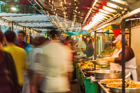 People walking on street food market in Bangkok, Thailand. Blurred motion.の写真素材
