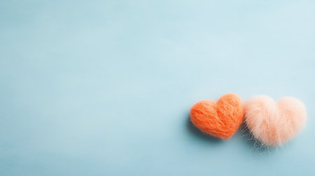 Two orange hearts on a blue background with copy space. Valentines day background.の写真素材