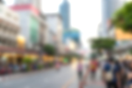 This image captures a vibrant street scene in an urban setting, showcasing a lively atmosphere filled with people engaging in various activities during the day.の写真素材