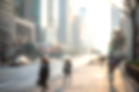 A dynamic urban scene showing blurred figures of people walking along a sunlit street surrounded by...