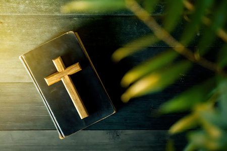 A serene image featuring a wooden cross resting atop a black bible, complemented by gentle green...