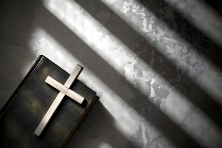 A wooden cross rests on a closed bible, illuminated by soft sunlight creating gentle shadows,...
