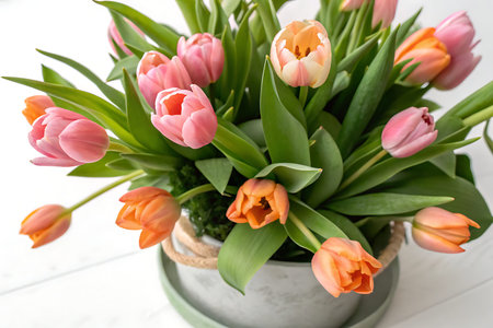 A stunning arrangement of vibrant tulips in shades of pink and orange, perfect for spring decor....