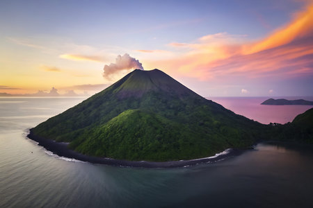 A breathtaking view of a majestic volcano surrounded by lush greenery and tranquil waters during sunset. The vibrant sky and pristine landscape evoke a sense of adventure and wonder in nature's beauty.の写真素材