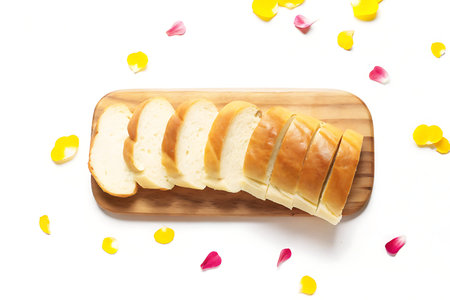 A beautifully arranged image featuring freshly sliced bread on a wooden cutting board, artistically...