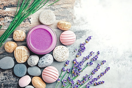 A serene flat lay of spa products featuring lavender, stones, and purple scrub, designed for relaxation and self-care routines. Perfect for wellness themes.の写真素材