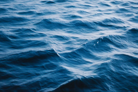 Capture the essence of tranquility with this image of gentle ocean waves, showcasing a serene blue surface reflecting soft light and inviting peace.の写真素材