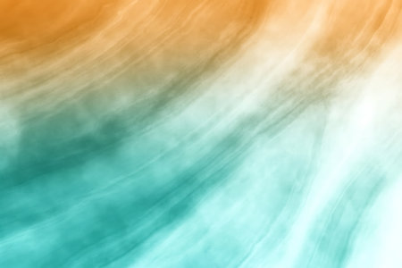 This image features a soft and fluid abstract gradient background with warm orange and cool teal colors, creating a serene and vibrant atmosphere suitable for various design needs.の写真素材