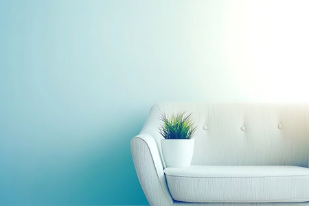 Modern sofa adorned with a potted plant in a soft blue room, creating a tranquil atmosphere perfect for relaxation and stylish home decor.の写真素材
