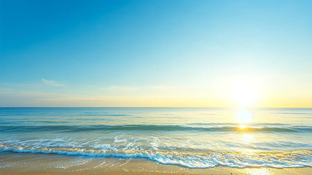 Experience the peaceful beauty of a serene ocean view at sunrise. Gentle waves lap against the sandy shore under a clear blue sky, creating a perfect tranquil scene.の写真素材