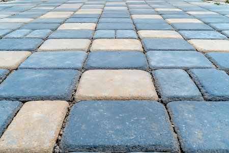 Close-up view of a walkway made from gray and beige pavers, showcasing textured patterns ideal for landscaping and outdoor design projects.の写真素材
