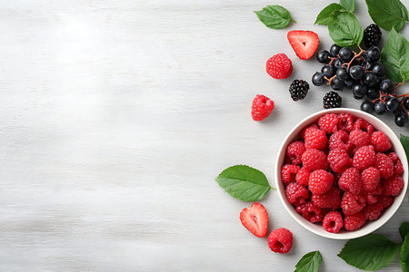 A vibrant assortment of fresh berries, featuring raspberries, strawberries, and blackberries,...