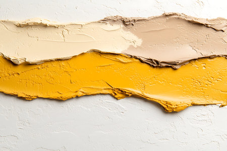 This image showcases vibrant paint strokes in warm tones of yellow, beige, and cream on a white...