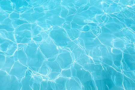 This image showcases a stunning blue water surface with gentle ripples, reflecting sunlight...