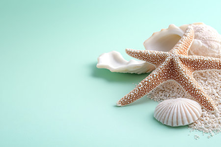 Discover a serene arrangement featuring a starfish and seashells on a soft mint background, perfect...