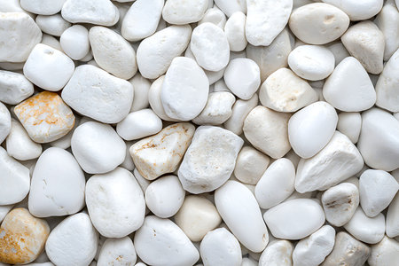 A collection of smooth white pebbles creating a serene and elegant surface. This image is perfect for various design projects, including gardening, minimal decor, and artistic presentations.の写真素材