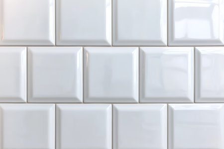 A close-up view of a white glossy subway tile wall showcasing a sleek and modern design. This image highlights the shiny surface and seamless layout ideal for various interior spaces.の写真素材