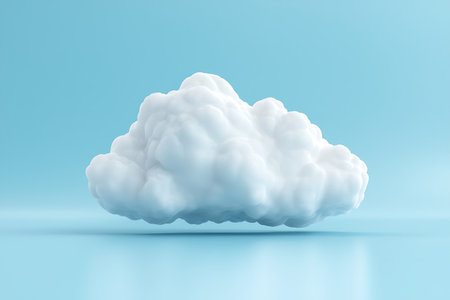 A soft white cloud floats gently against a light blue background, creating a tranquil and serene atmosphere perfect for various creative projects and designs.の写真素材