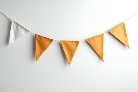 A vibrant string of triangle flags in yellow and white creates a festive atmosphere perfect for party decorations, celebrations, and more.の写真素材